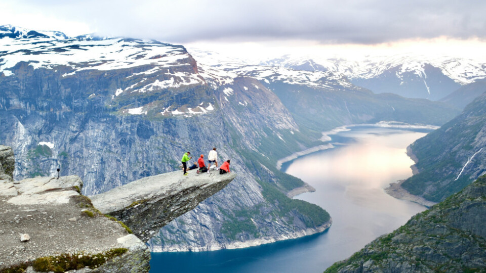 A group of people on Trolltunga [A rocky outcrop high over a fjord ]